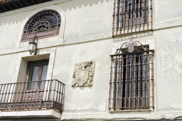 Old iron window with wooden edges on a Spanish street. Traditional architecture in spain