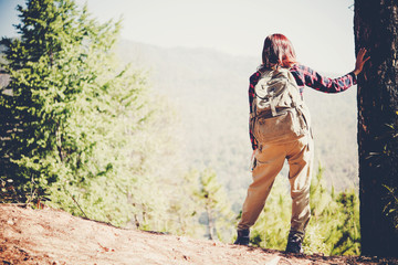 Hiker with backpack standing on the mountain