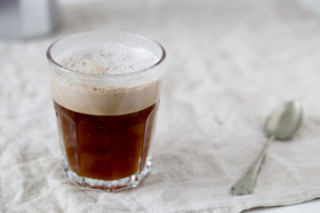 Glass of dark beer on white textile background