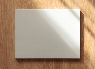 Blank canvas on wooden wall