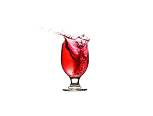 Wine or other red drink poured in a glass and splashes