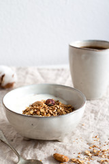Healthy breakfast. Fresh granola, muesli in a rustic style bowl on white background. Good morning concept for your design 