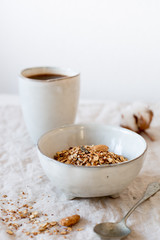 Healthy breakfast. Fresh granola, muesli in a rustic style bowl on white background. Good morning concept for your design 