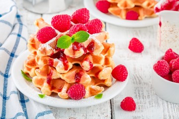 Homemade waffles with fresh raspberries for breakfast