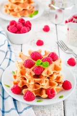 Homemade waffles with fresh raspberries for breakfast