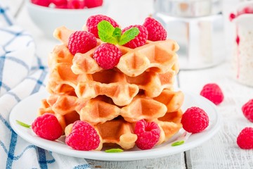 Homemade waffles with fresh raspberries for breakfast