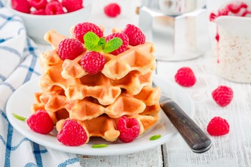 Homemade waffles with fresh raspberries for breakfast