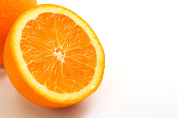 Orange cut in half on white background, selective focused.