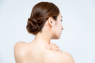 young beautiful woman massaging her shoulder.