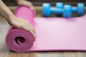 Young woman holding a yoga mat