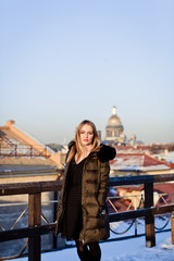 Picture of a girl against a background of snow and the city