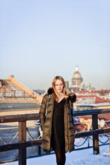 Picture of a girl against a background of snow and the city