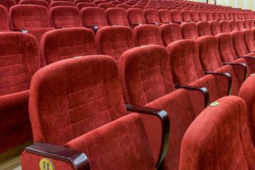 Rows of empty red velvet seats