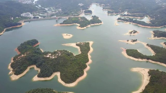 Aerial view over Hong Kong Tai Lam Chung Reservoir under smokey weather
