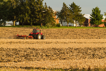 a farmer discing his field on a cool October afternoon.