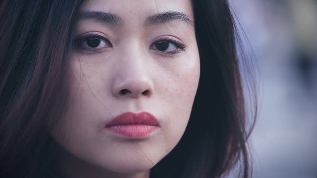 depressed and sad chinese woman in the city: Closeup Portrait