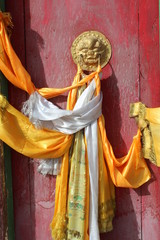 Obraz premium Amdo Tibet Tibetan Monastery Monasteries Monastic Door Gate Doors Gates Red Prayer Flag Flags Scarf Scarves White Yellow Traditional Lion Knocker Knock Ancient Style Tradition Asian Asia China Qinghai