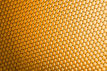 abstract texture honeycomb. Metallic net background or texture. metal mesh. full frame colourful illuminated detail of a metallic grid in front of a loudspeaker