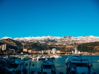 Fototapeta na wymiar Luxury yachts on the coast in winter season. Marina in Budva, Montenegro