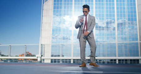 Young urban street dancer in smart suit showing off some moves in city