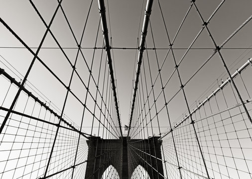 Fototapeta Brooklyn Bridge towers, in Black & White, with double gothic arches and symmetrical suspension cables, New York City