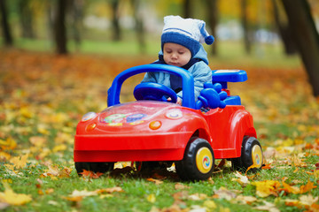 little funny boy driving toy car