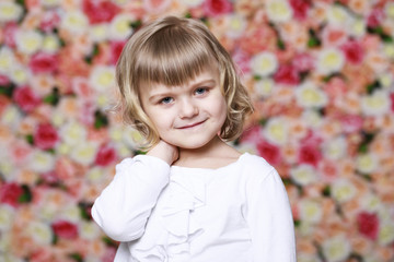 Portrait of a beautiful young little girl in white gown