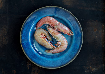 Seafood royal shrimp or king prawns on blue rustic plate