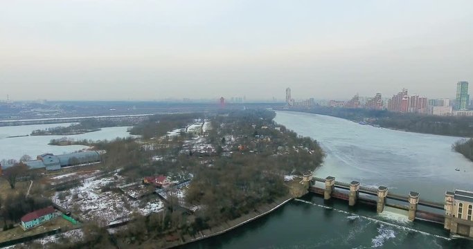 Dam. The discharge of water. City on background. 4K