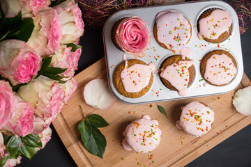 Fototapeta na wymiar Cupcake with pink glaze on the wooden background. Selective focus.