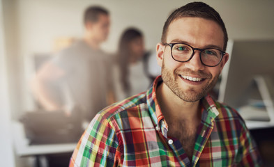 Cheerful entrepreneur wearing glasses in the office