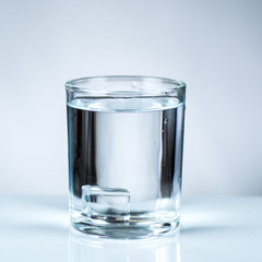 ice cube in glass of water