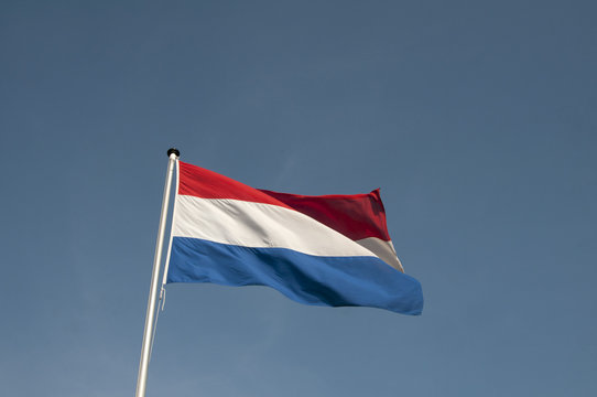 The Dutch red and white flag blowing in the wind