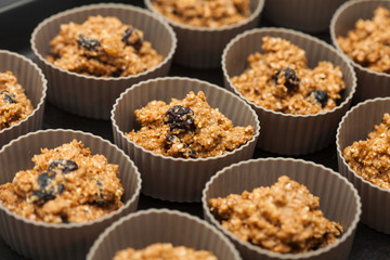 Wheat bran muffins preparation : Adding wheat bran muffins mix to the baking cups