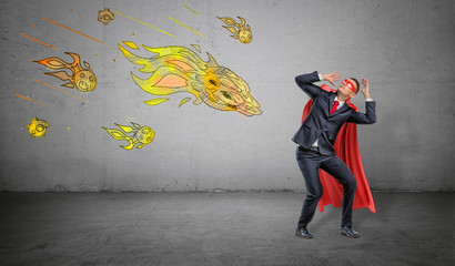 A scared businessman in a superhero cape cowering under an attack of yellow paper comets on...