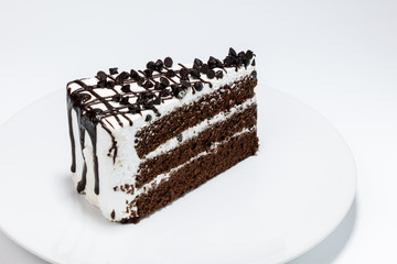 chocolate chip topping on chocolated cake on white background
