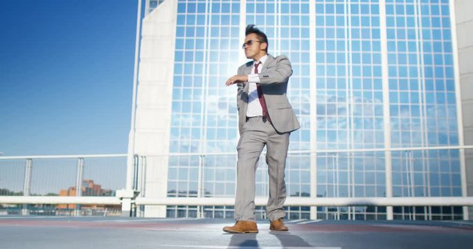  Young urban street dancer in smart suit showing off some moves in city