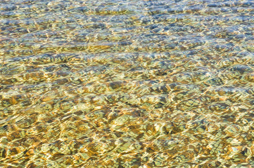 The water in the pool has a tile bottom tile glittering in the sun. Background, texture