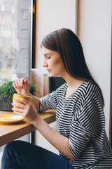 Girl drinking coffee in a coffee shop