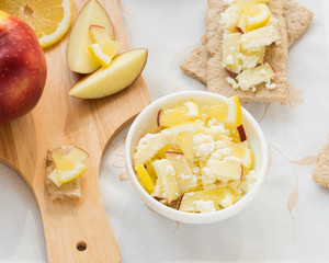 Healthy breakfast. Fresh healthy snack. Fruit salad with crispbread. Apples, lemon, sweet cottage cheese