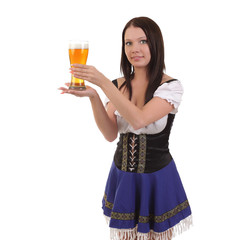 young woman in traditional bavarian dress holding mug of beer.