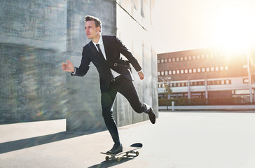 Confident skater wearing suit riding in city