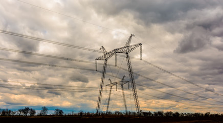 high-voltage power lines at sunset. electricity distribution station. high voltage electric transmission tower