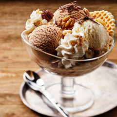 Tasty ice cream dessert in glass bowl