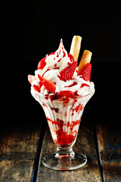 Ice cream sundae with strawberry sauce