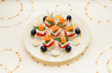 Cold snacks. Canapes of feta cheese and vegetables