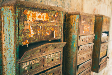 Few old mailboxes hanging on the wall. Rusted Mailboxes. Mail from the past