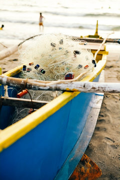 Blue fishing boat parked on the beach