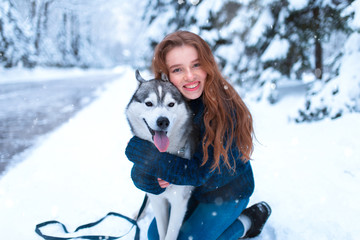 Woman hugs with siberian husky, friendship forever