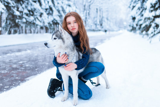 Woman hugs with siberian husky, friendship forever
